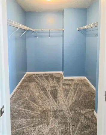 a bedroom with a bed and cabinets