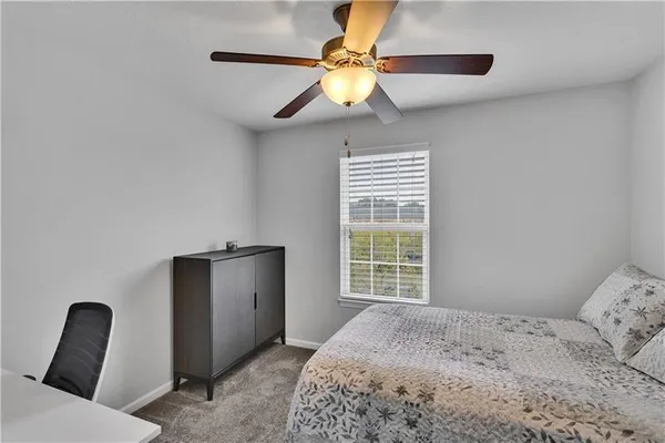 a bedroom with a bed and a chair