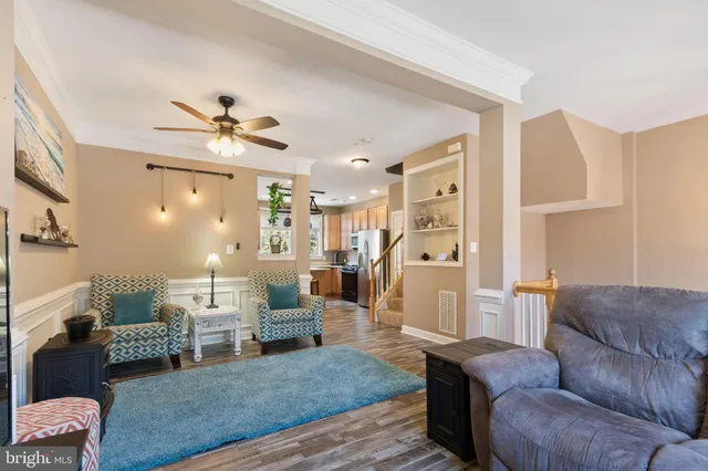 a kitchen with kitchen island granite countertop a sink a counter space appliances and a window