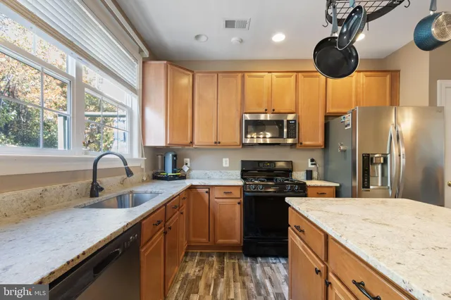 a front view of a house with a garden and plants