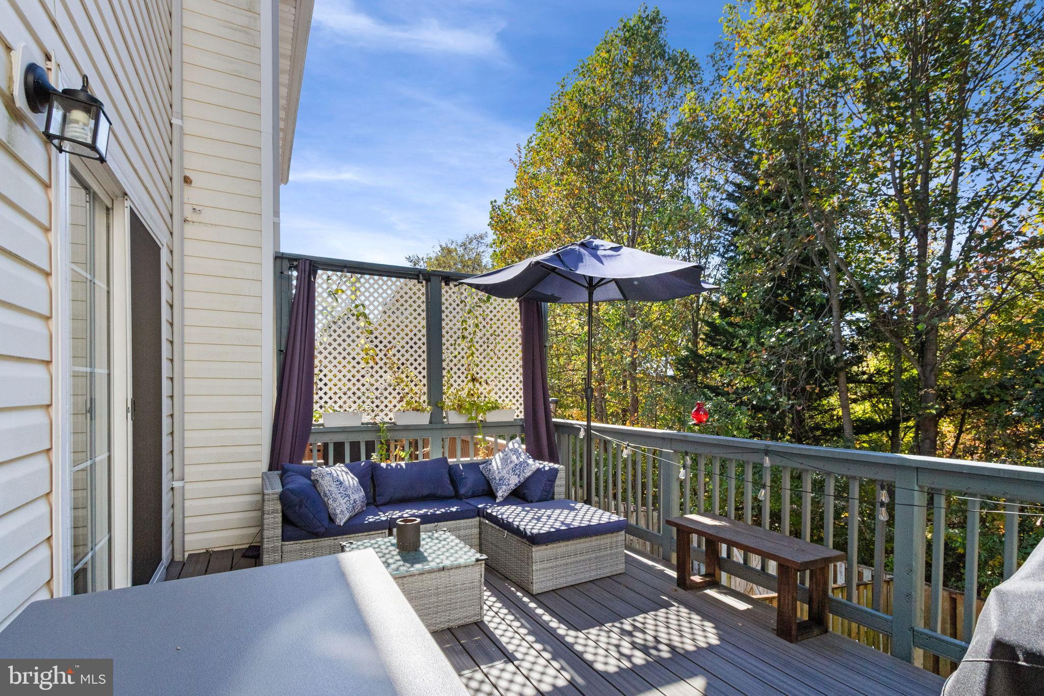 15636 Avocet Loop Woodbridge, VA 22191 - Photo 24 of 60 a view of balcony with furniture and umbrella
