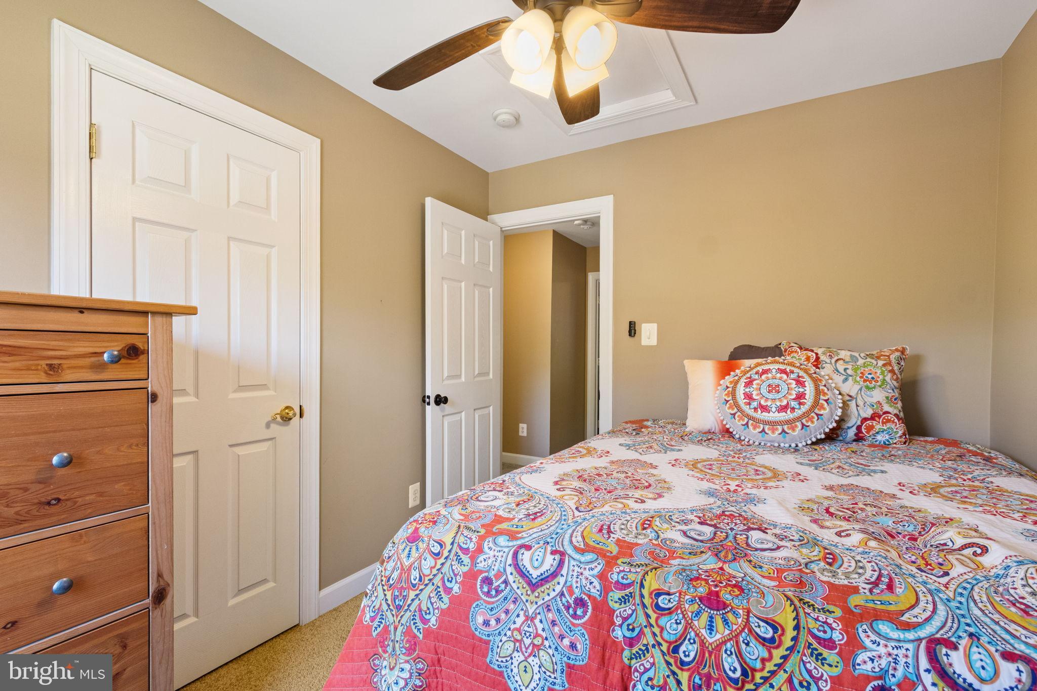 15636 Avocet Loop Woodbridge, VA 22191 - Photo 30 of 60 a bedroom with a bed and wooden floor