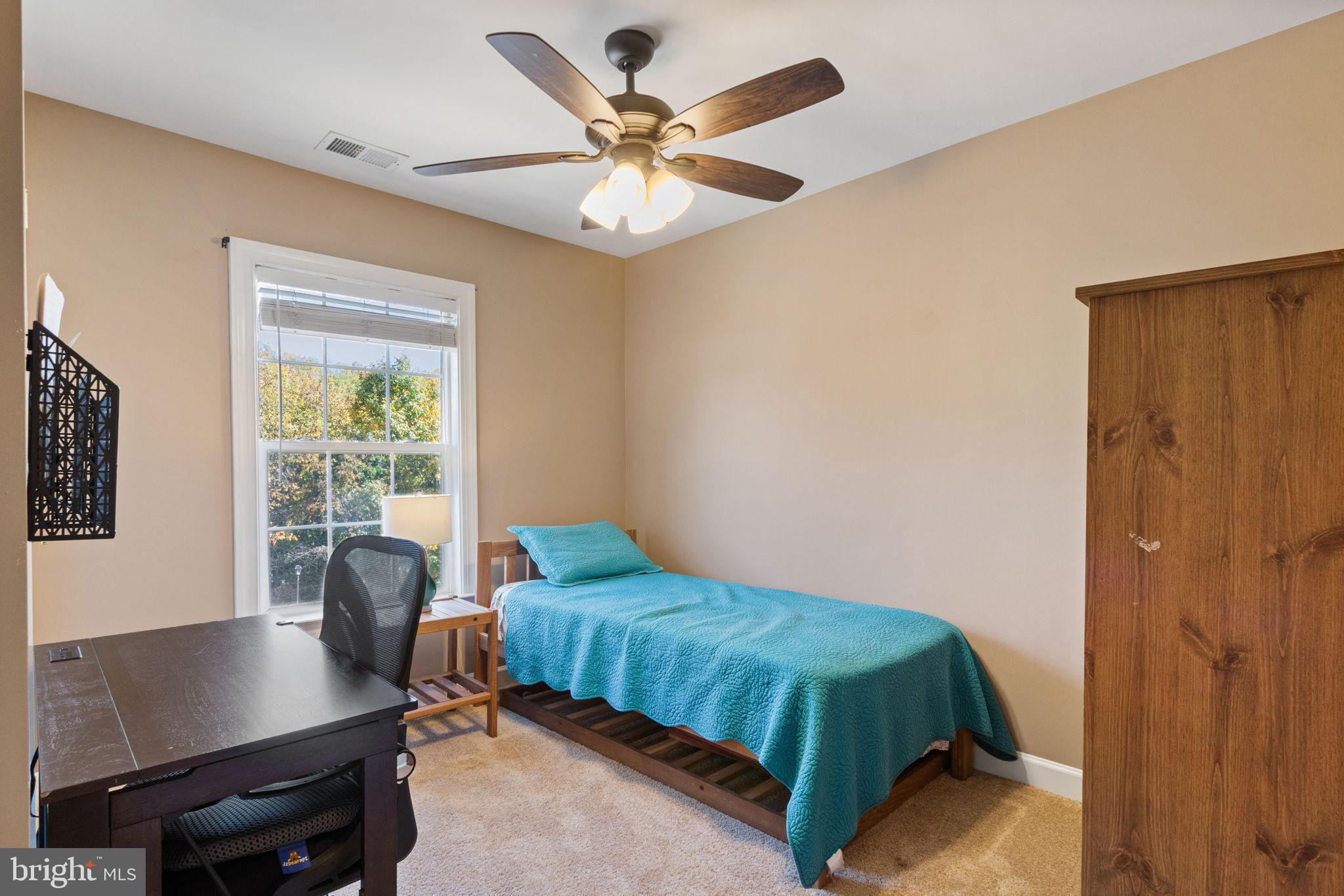 15636 Avocet Loop Woodbridge, VA 22191 - Photo 31 of 60 a bedroom with a bed and a desk