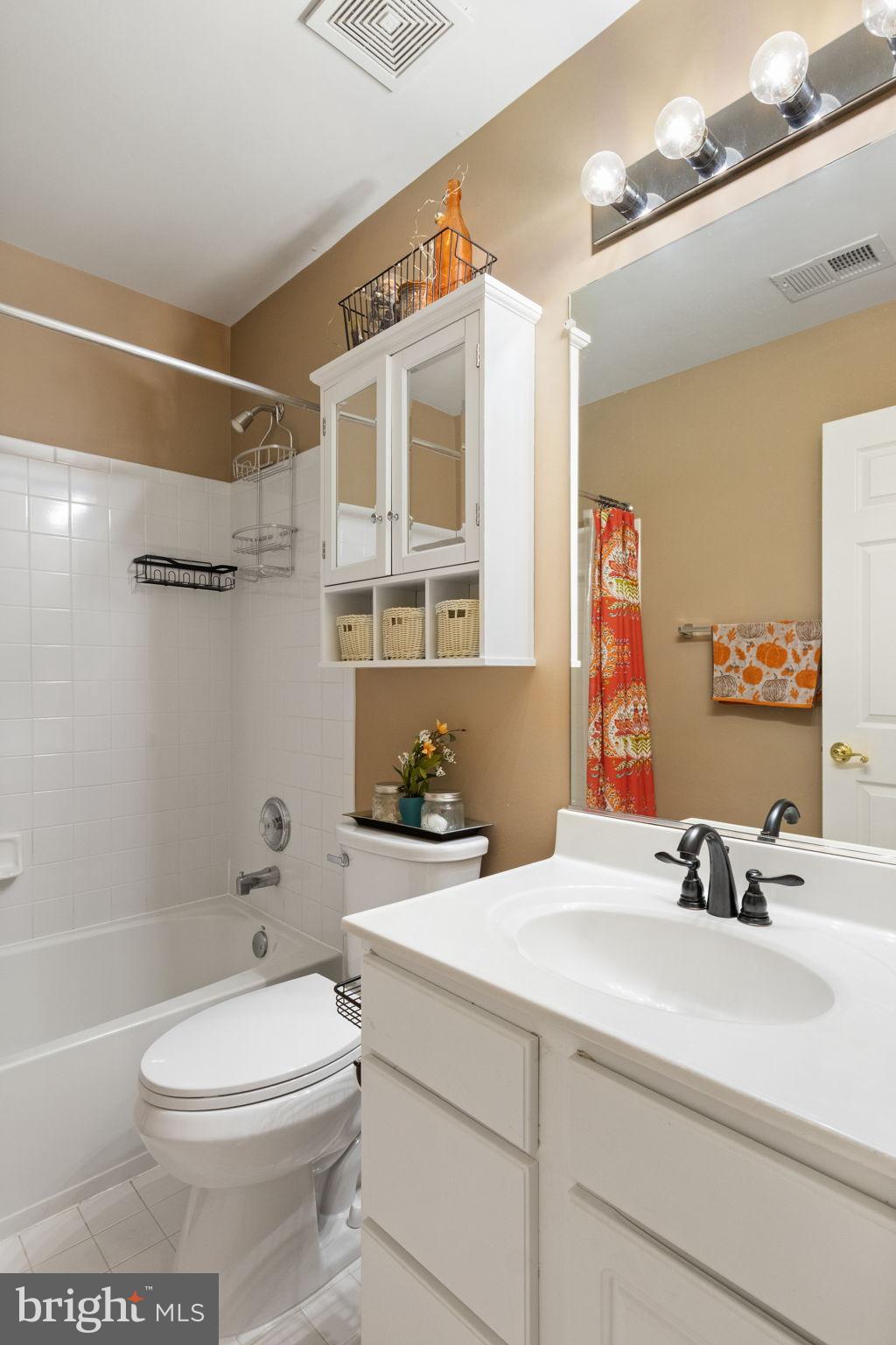 15636 Avocet Loop Woodbridge, VA 22191 - Photo 34 of 60 a bathroom with a sink a toilet and shower