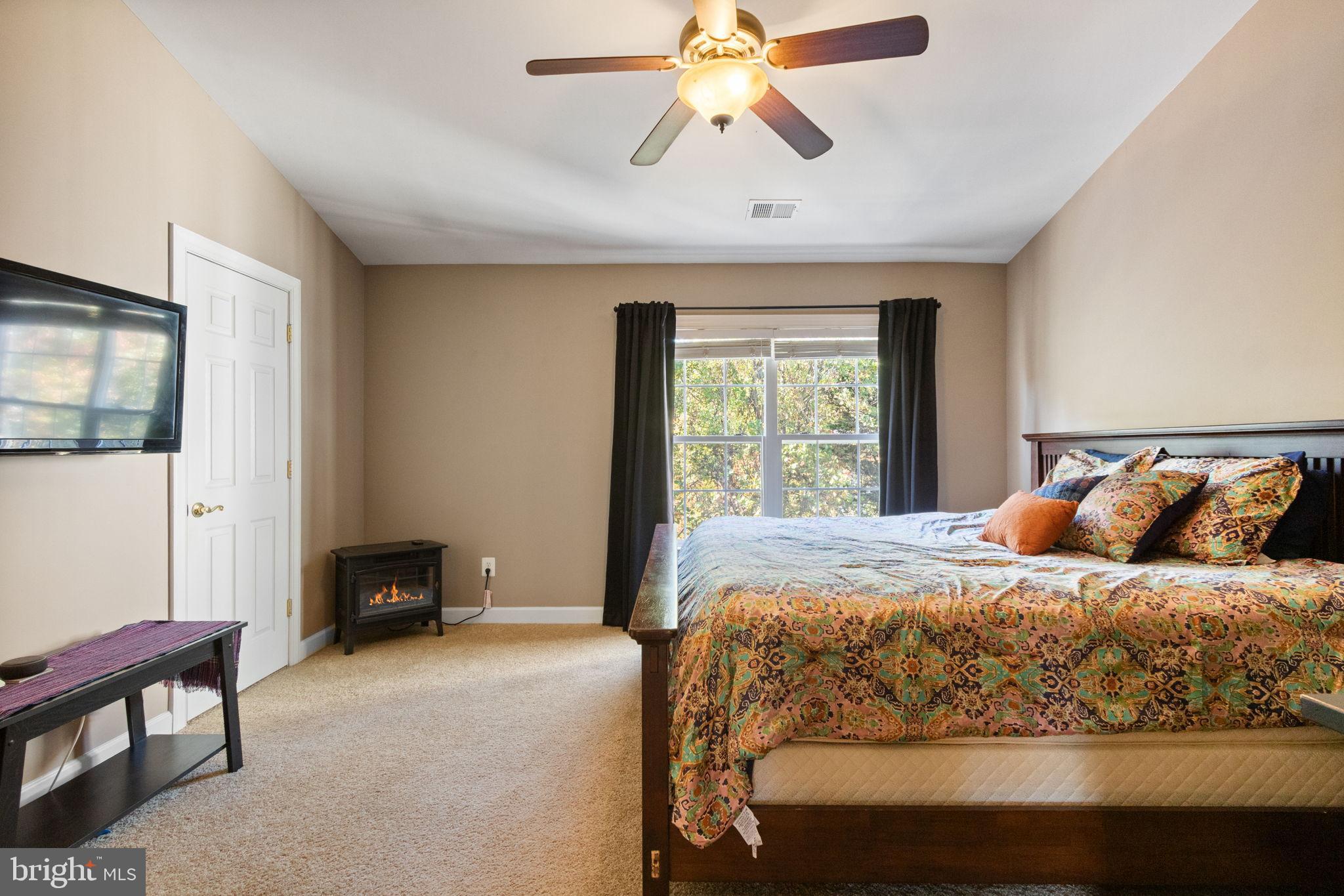 15636 Avocet Loop Woodbridge, VA 22191 - Photo 35 of 60 a bedroom with a bed and a chandelier