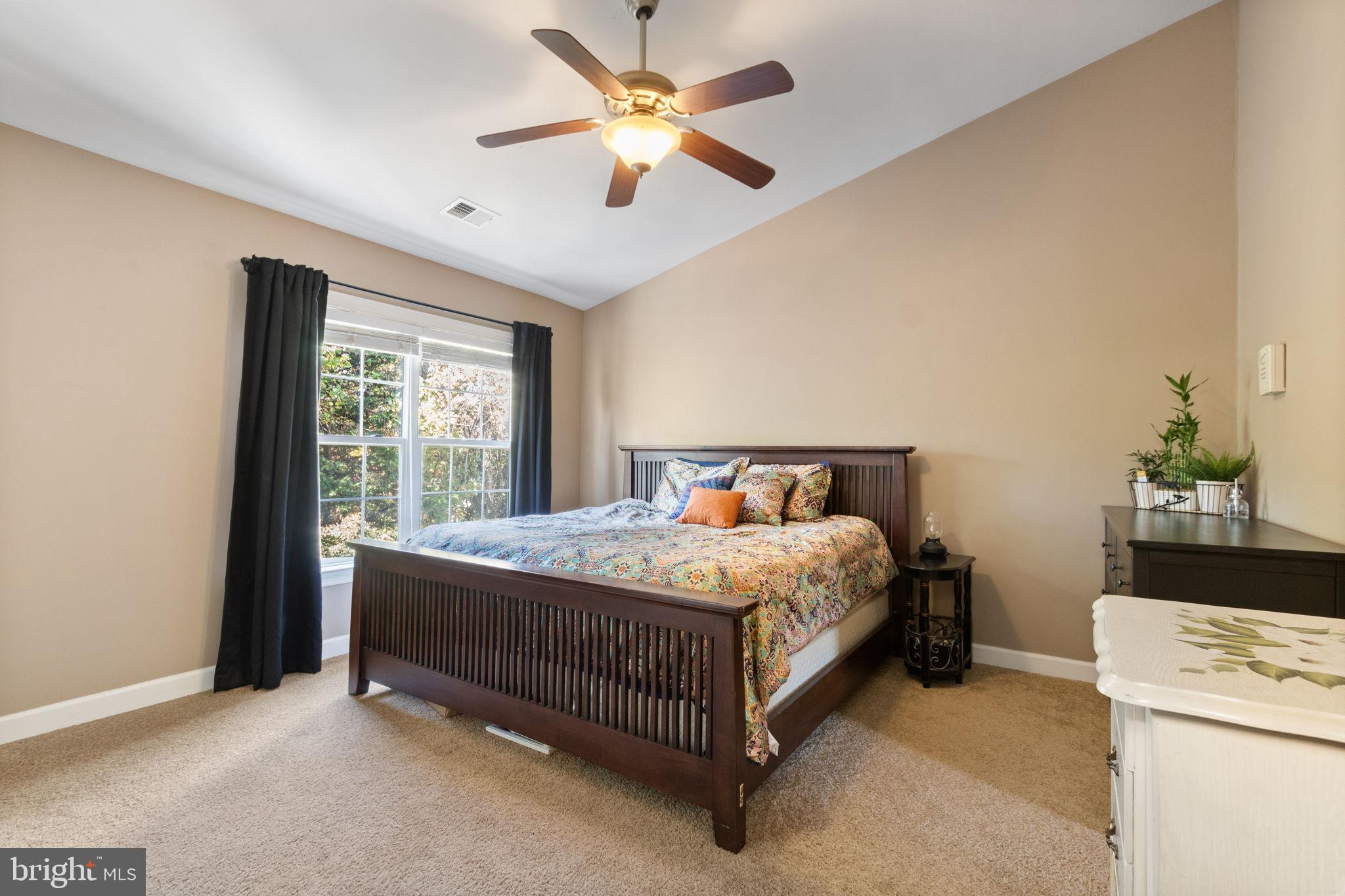 15636 Avocet Loop Woodbridge, VA 22191 - Photo 36 of 60 a bedroom with a bed and a chandelier fan