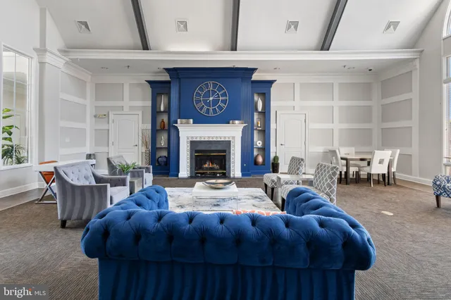 a room with wooden floor pool table and windows