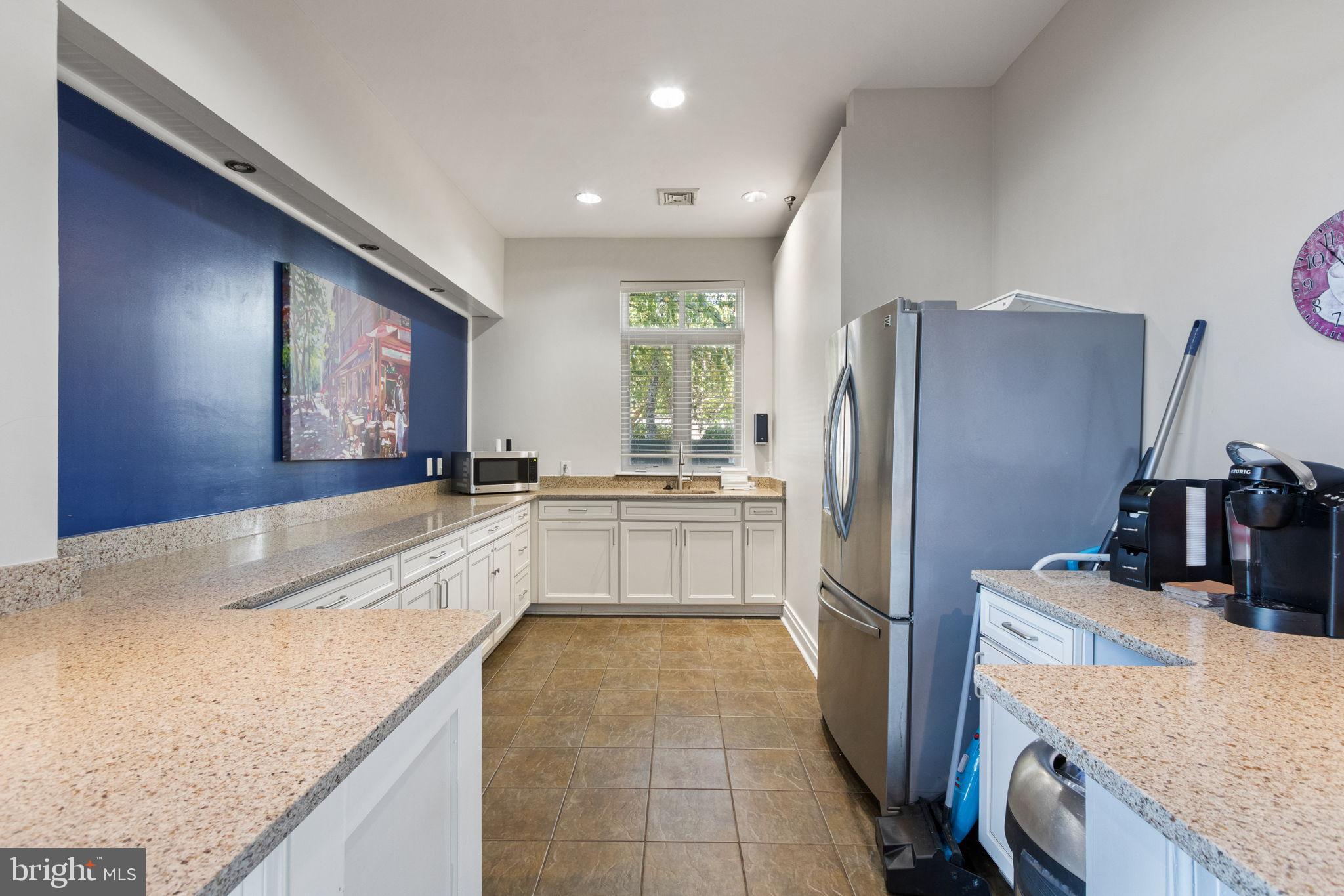 15636 Avocet Loop Woodbridge, VA 22191 - Photo 45 of 60 a large kitchen with granite countertop a sink stove and refrigerator