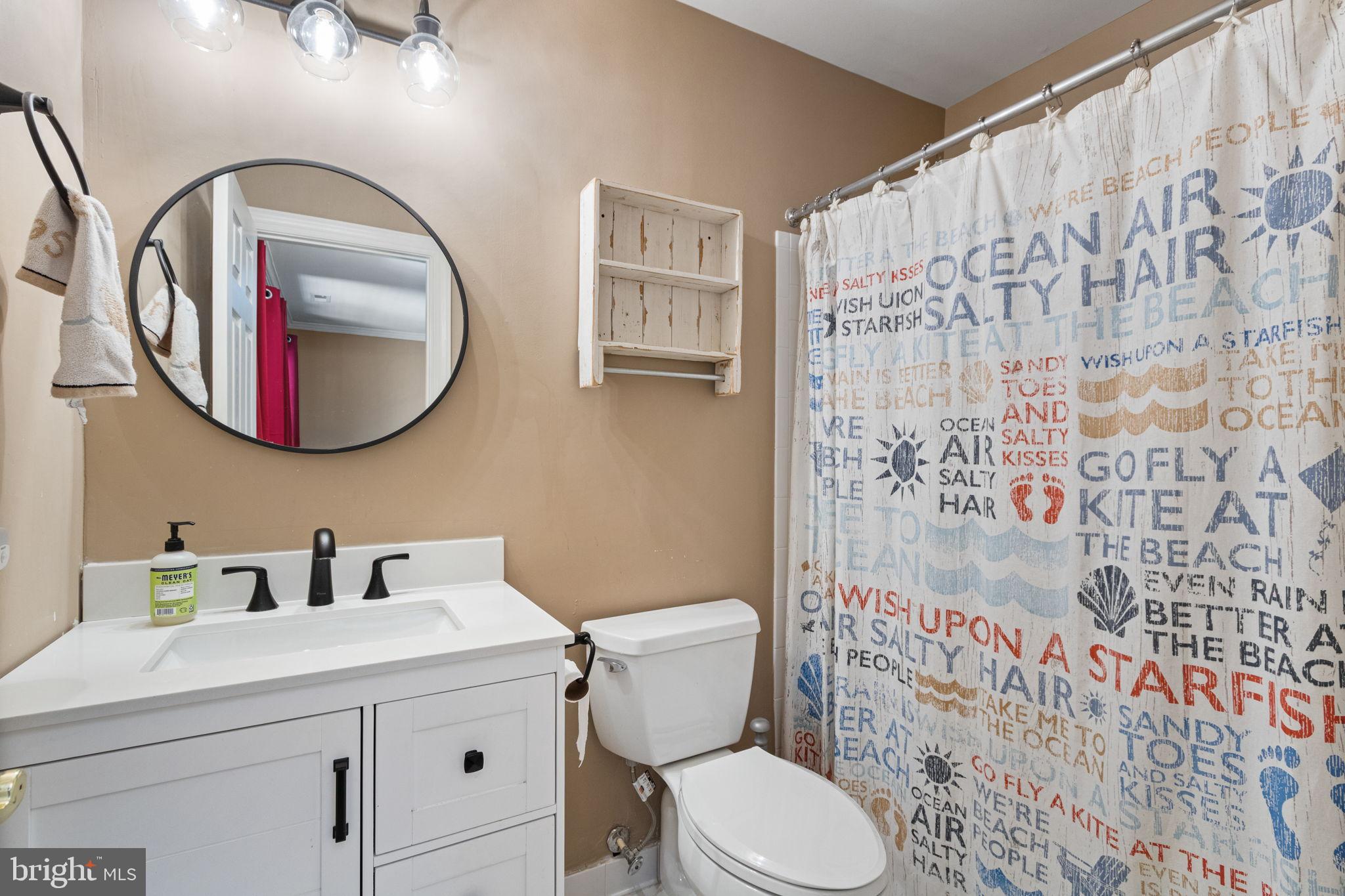 15636 Avocet Loop Woodbridge, VA 22191 - Photo 8 of 60 a bathroom with a toilet sink and mirror