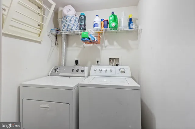 a living room with couches chairs and kitchen view