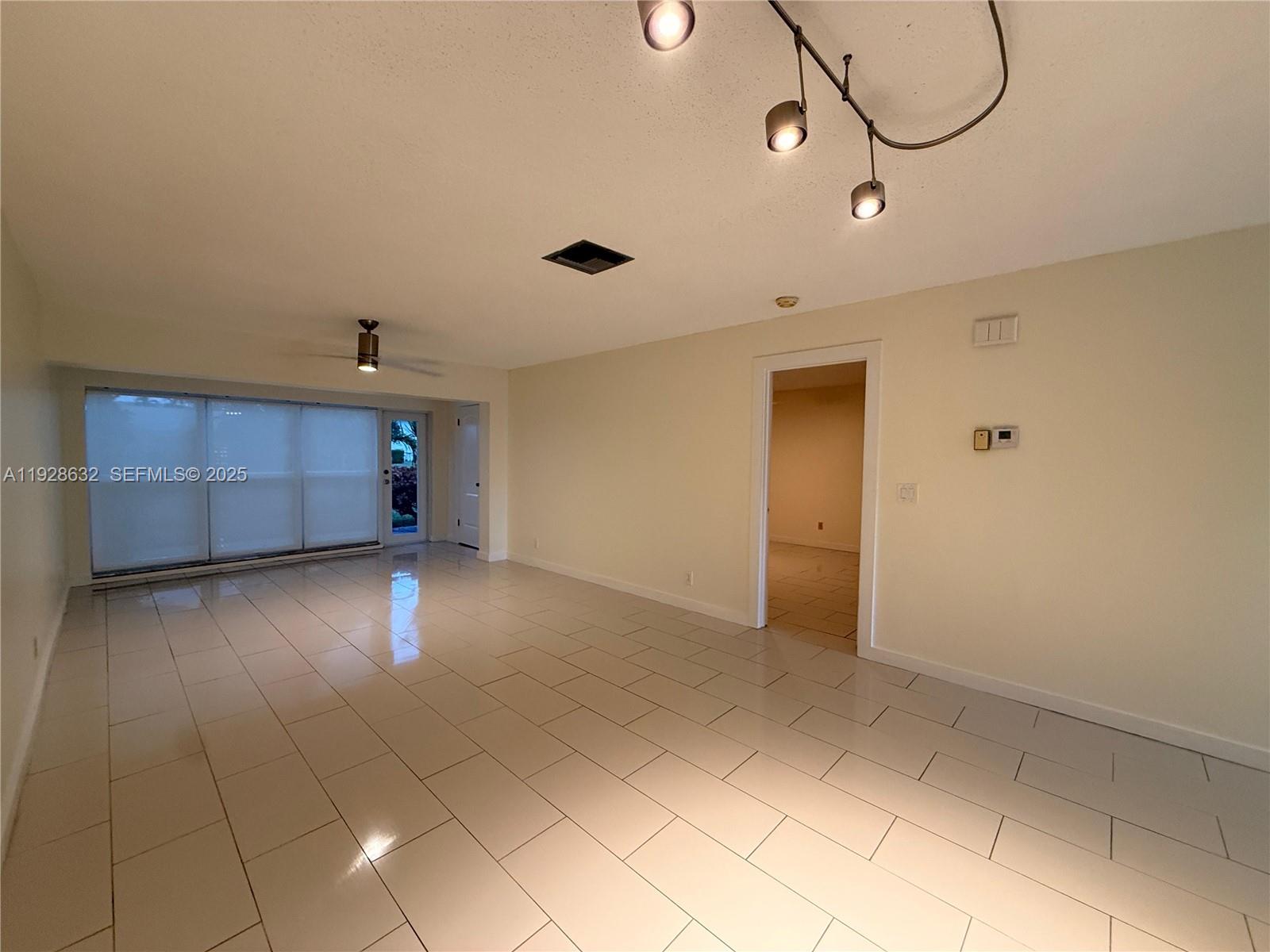 13741 Flora Place, Unit B Delray Beach, FL 33484 - Photo 12 of 50 a view of a room with wooden floor and cabinets