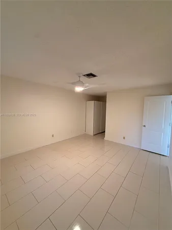 a view of an empty room and a window