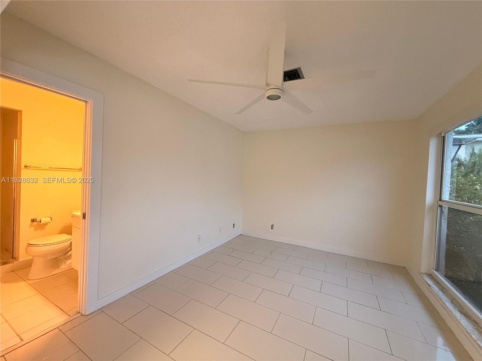 13741 Flora Place, Unit B Delray Beach, FL 33484 - Photo 36 of 50 an empty room with windows