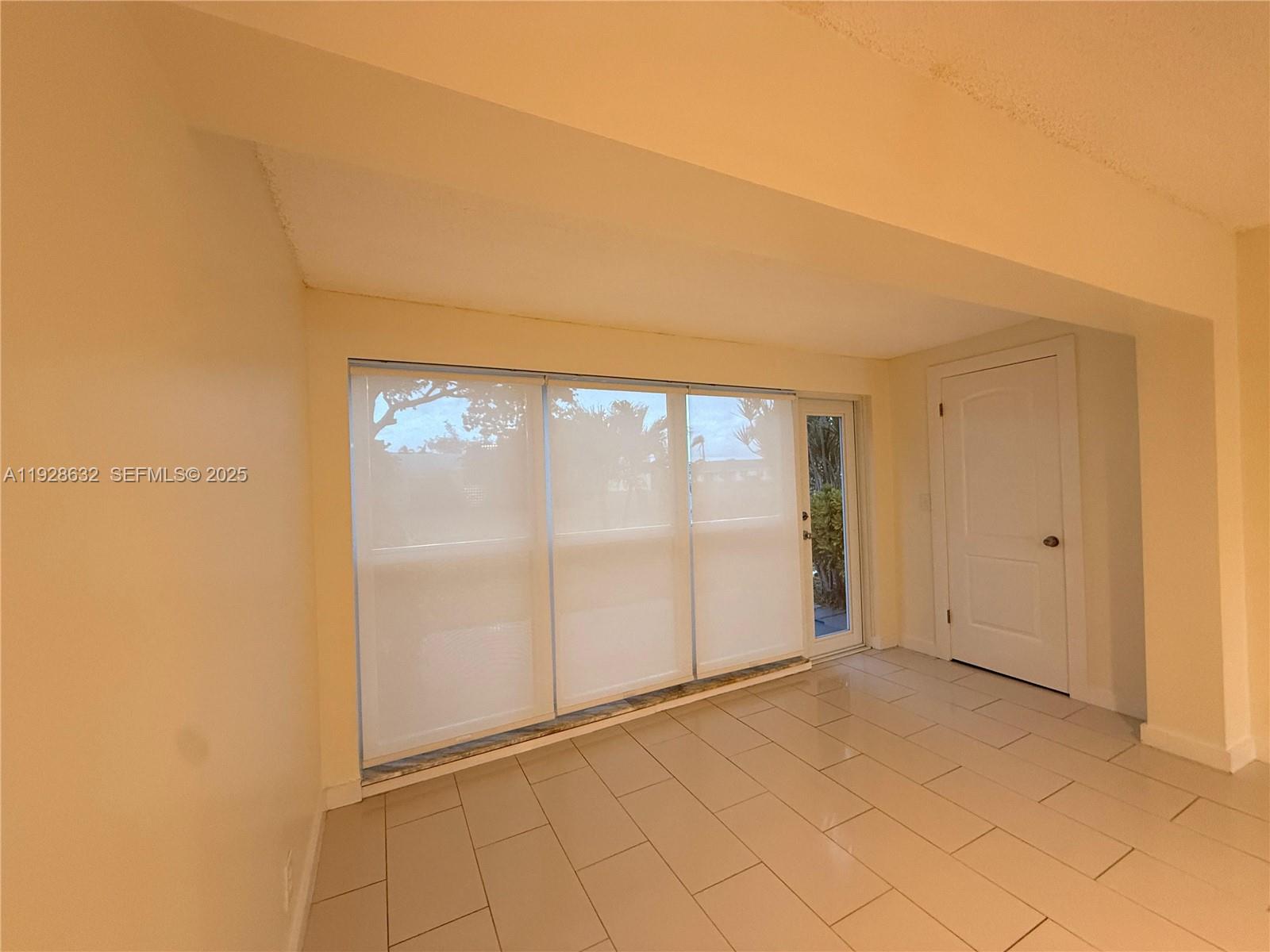 13741 Flora Place, Unit B Delray Beach, FL 33484 - Photo 46 of 50 a view of an empty room with a window