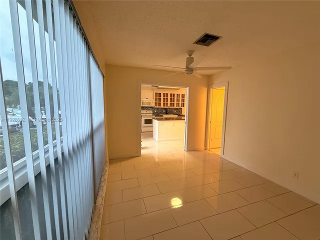 a view of a hallway to the door