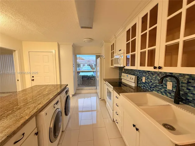 a spacious bathroom with a granite countertop sink and a bathtub