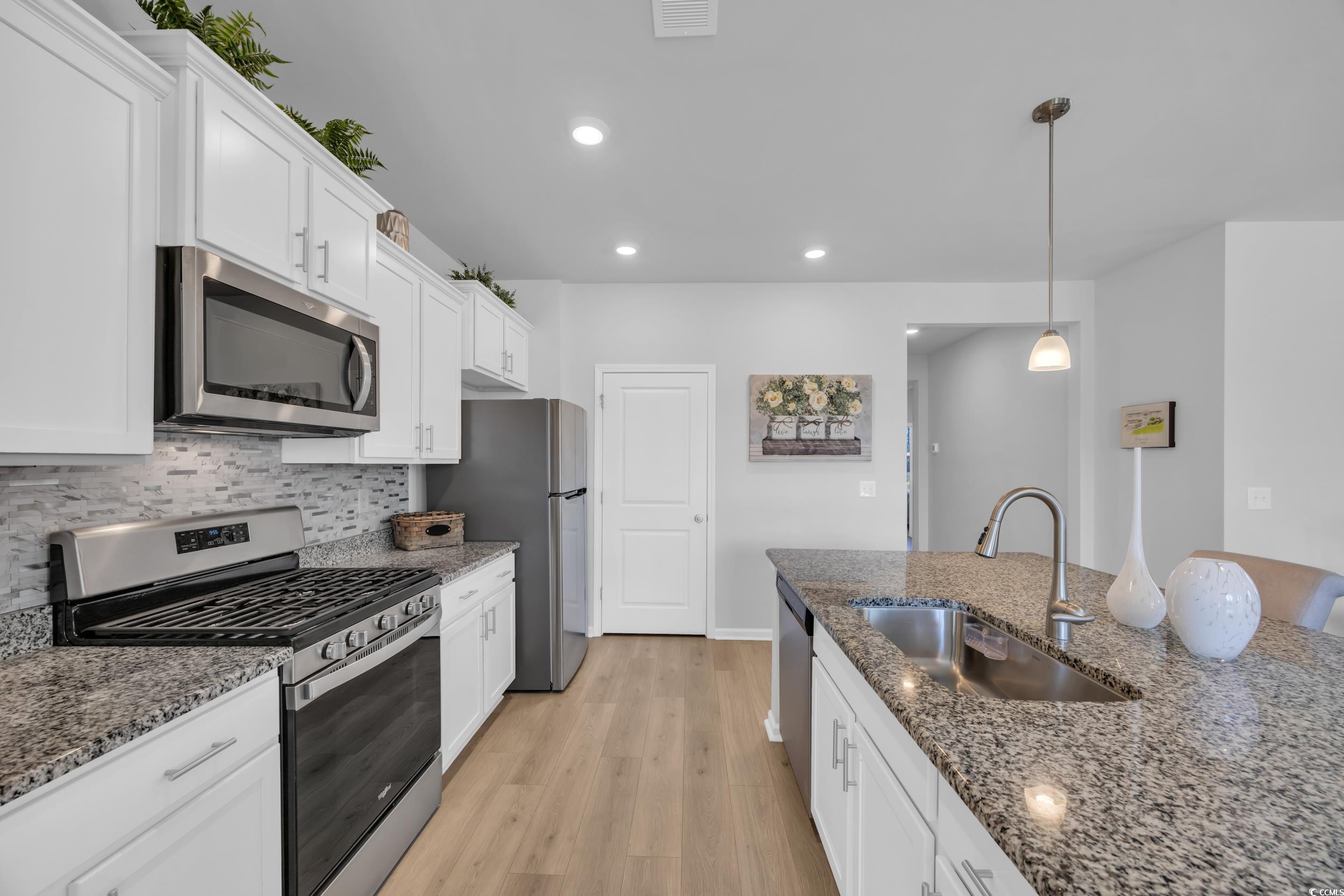 223 Juniata Loop Little River, SC 29566 - Photo 16 of 39 Kitchen with decorative backsplash, white cabinets