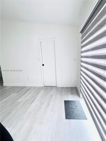 a view of wooden floor and windows in a room