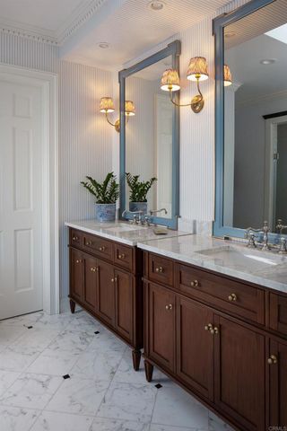 a spacious bathroom with a double vanity sink and a mirror