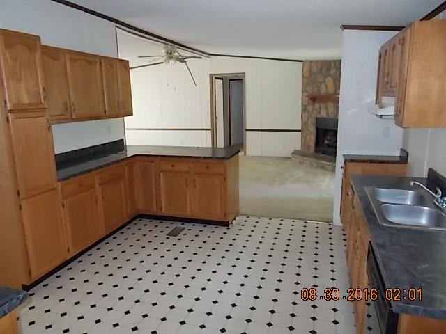 1973 South Commerce Road Watertown, TN 37184 - Photo 2 of 22 a kitchen with a sink a refrigerator and cabinets