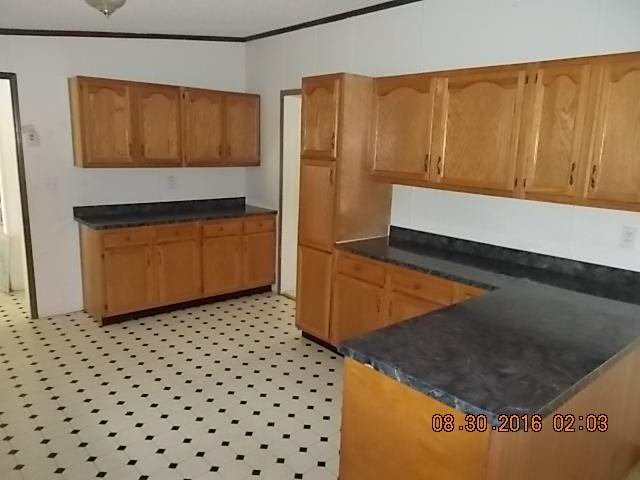 1973 South Commerce Road Watertown, TN 37184 - Photo 11 of 22 a kitchen with a refrigerator and cabinets