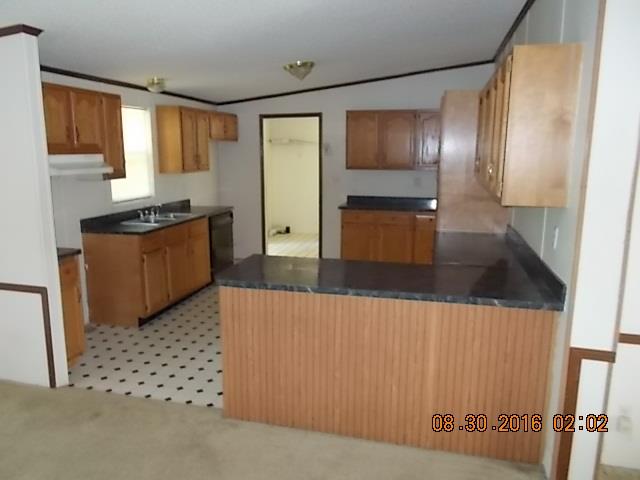 1973 South Commerce Road Watertown, TN 37184 - Photo 6 of 22 a kitchen with granite countertop a refrigerator and a stove