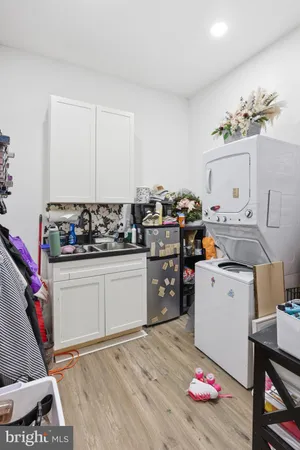 a kitchen with a stove a chimney a sink and cabinets