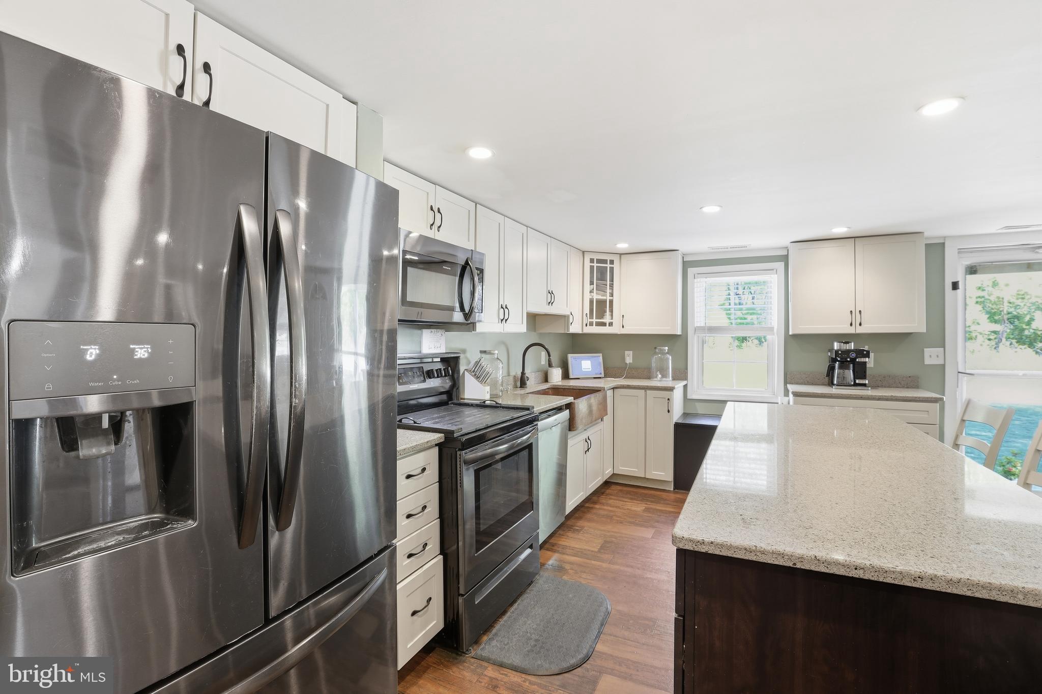 24815 Zoar Road Georgetown, DE 19947 - Photo 5 of 49 a large kitchen with stainless steel appliances lots of counter space and a sink