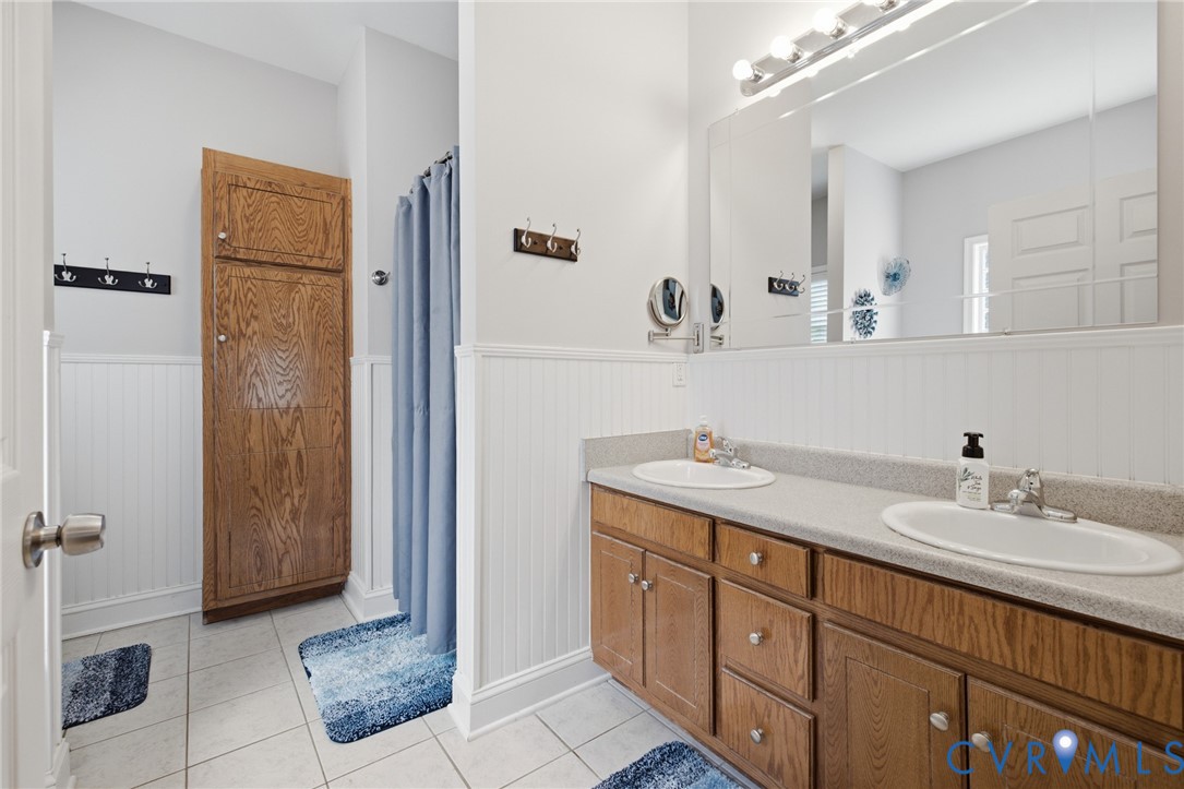 9433 Robin Road Disputanta, VA 23842 - Photo 22 of 26 Bathroom featuring a dual-sink vanity with light-c