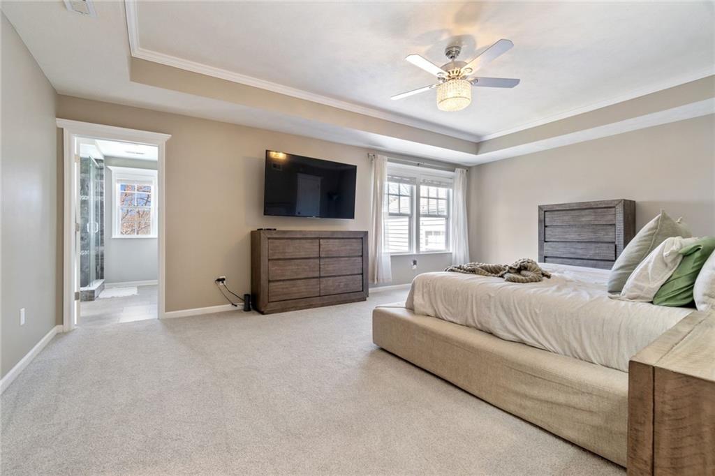 380 Trinity Way Wexford, PA 15090 - Photo 18 of 29 a spacious bedroom with a bed and a flat screen tv