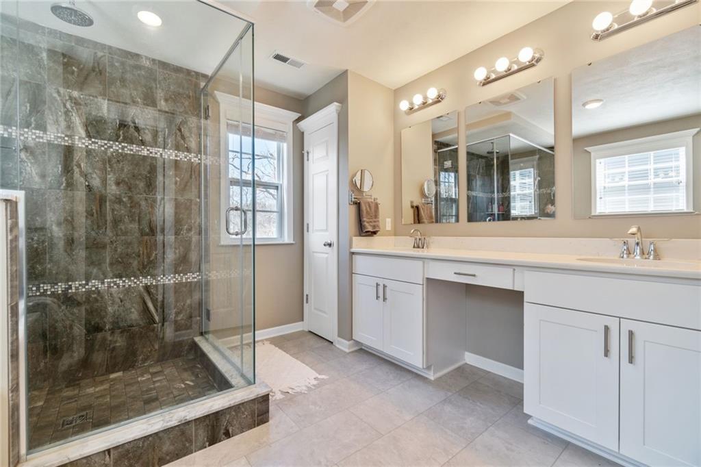 380 Trinity Way Wexford, PA 15090 - Photo 19 of 29 a bathroom with a shower sink and mirror
