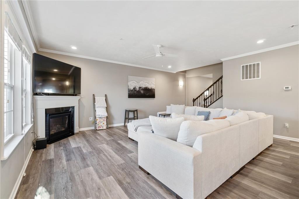 380 Trinity Way Wexford, PA 15090 - Photo 6 of 29 a living room with furniture a flat screen tv and a fireplace