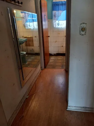 an empty room with wooden floor and closet