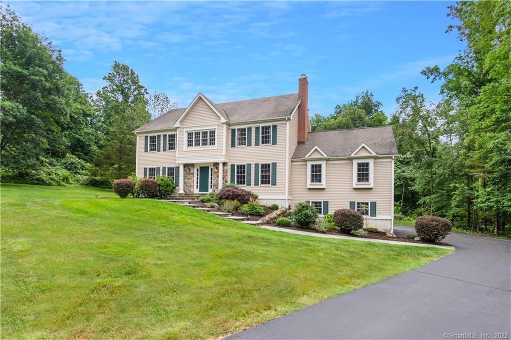 Front exterior with private large front yard.
