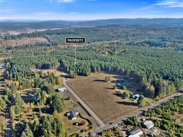 an aerial view of a house with yard