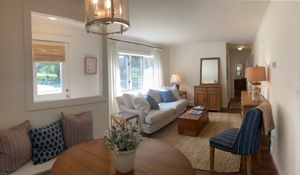 54 Grapevine Road Gloucester, MA 01930 - Photo 4 of 18 a living room with furniture and a chandelier