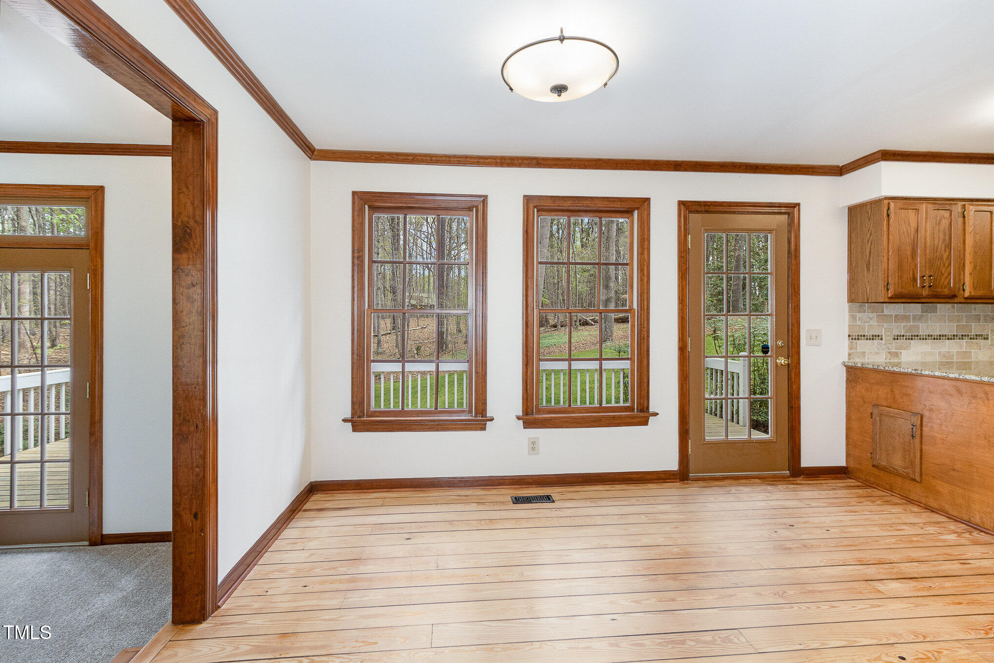 7212 Rabbit Run Wake Forest, NC 27587 - Photo 10 of 32 an empty room with wooden floor and windows