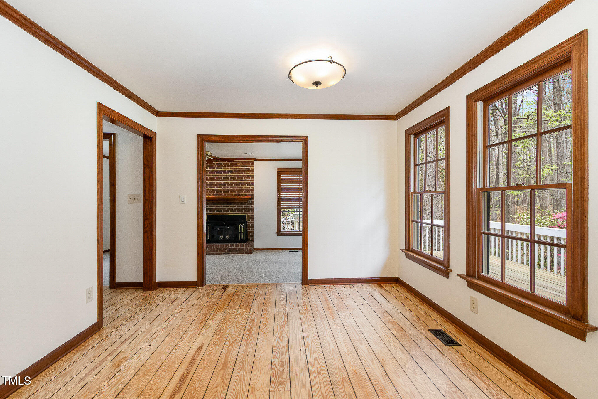 7212 Rabbit Run Wake Forest, NC 27587 - Photo 12 of 32 a view of an empty room with wooden floor and a window