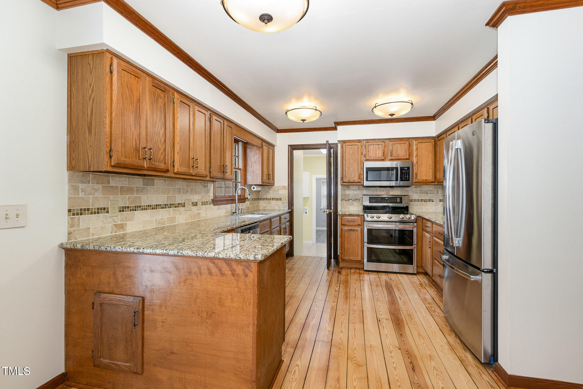 7212 Rabbit Run Wake Forest, NC 27587 - Photo 13 of 32 a kitchen with stainless steel appliances granite countertop a refrigerator a stove and a sink