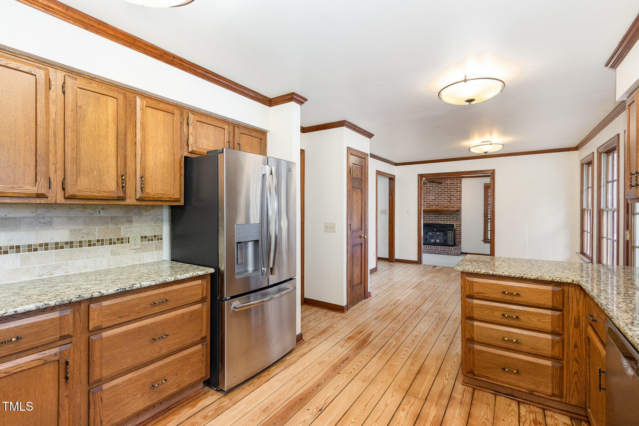 7212 Rabbit Run Wake Forest, NC 27587 - Photo 15 of 32 a kitchen with granite countertop a refrigerator and cabinets