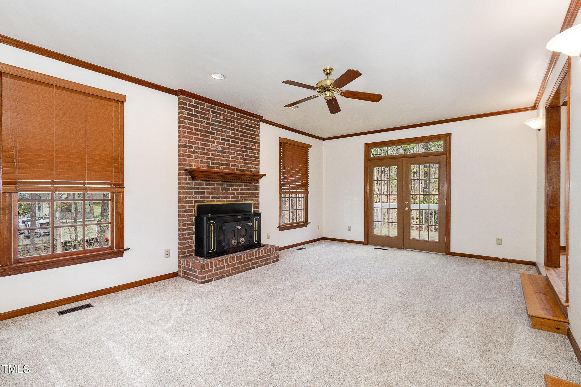 7212 Rabbit Run Wake Forest, NC 27587 - Photo 5 of 32 a view of a livingroom with a fireplace a ceiling fan and windows