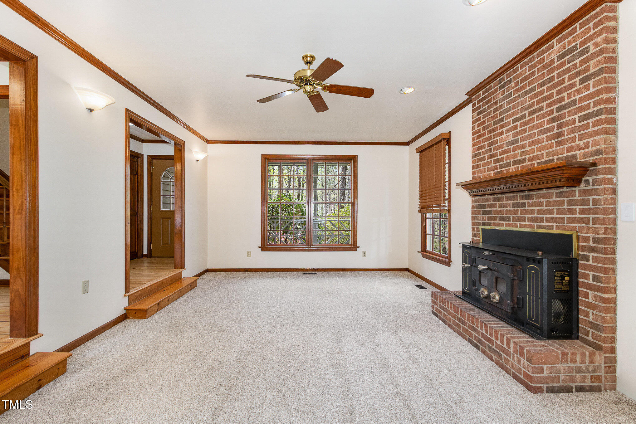 7212 Rabbit Run Wake Forest, NC 27587 - Photo 7 of 32 a view of an empty room with window and fire place