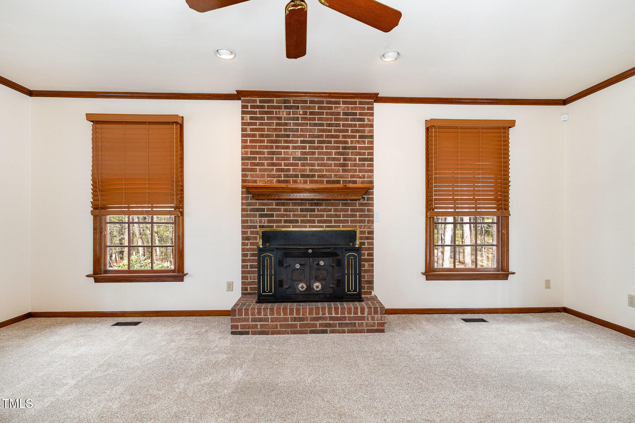 7212 Rabbit Run Wake Forest, NC 27587 - Photo 8 of 32 an empty room with windows and fireplace
