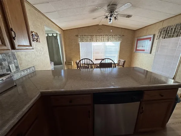 a kitchen with stainless steel appliances granite countertop a sink refrigerator and microwave