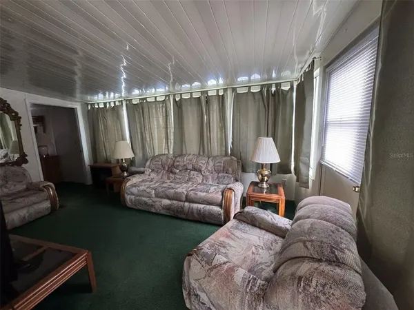 a view of living room with furniture and a window