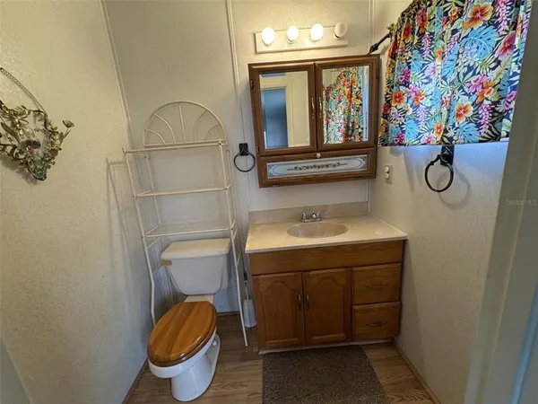 a bedroom with a bed and a mirror