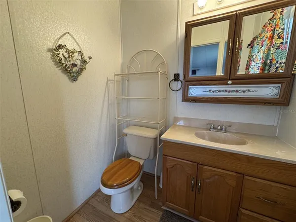 a bedroom with a bed and a mirror on the dresser