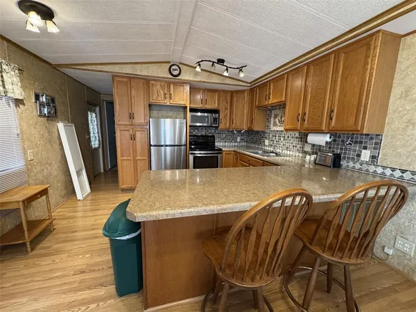 a kitchen with a sink stove and microwave