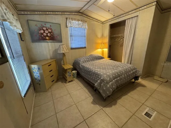 a bedroom with a bed and a stove
