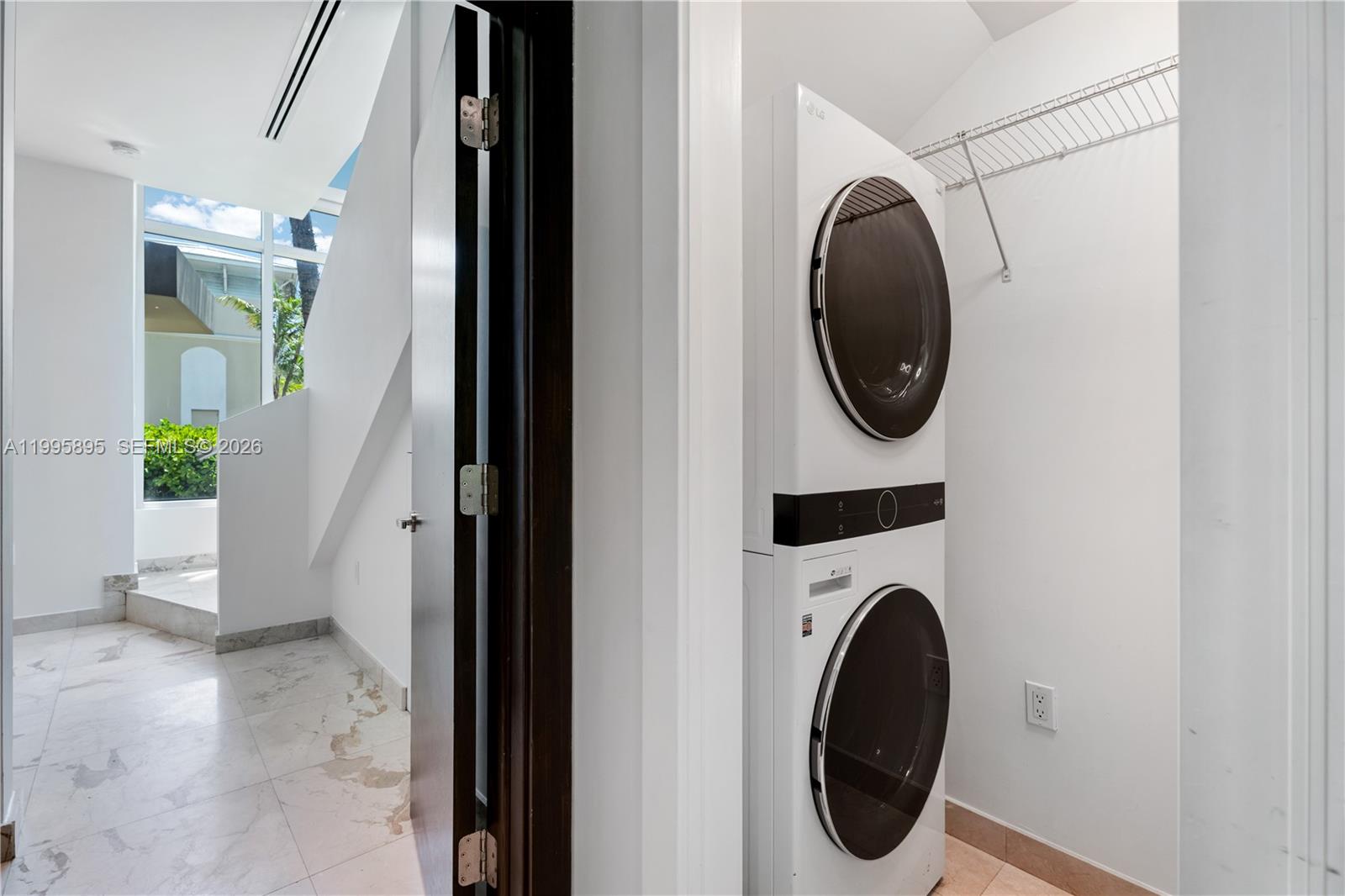 548 Fernwood Road, Unit 548 Key Biscayne, FL 33149 - Photo 11 of 50 a view of a hallway with washer and dryer